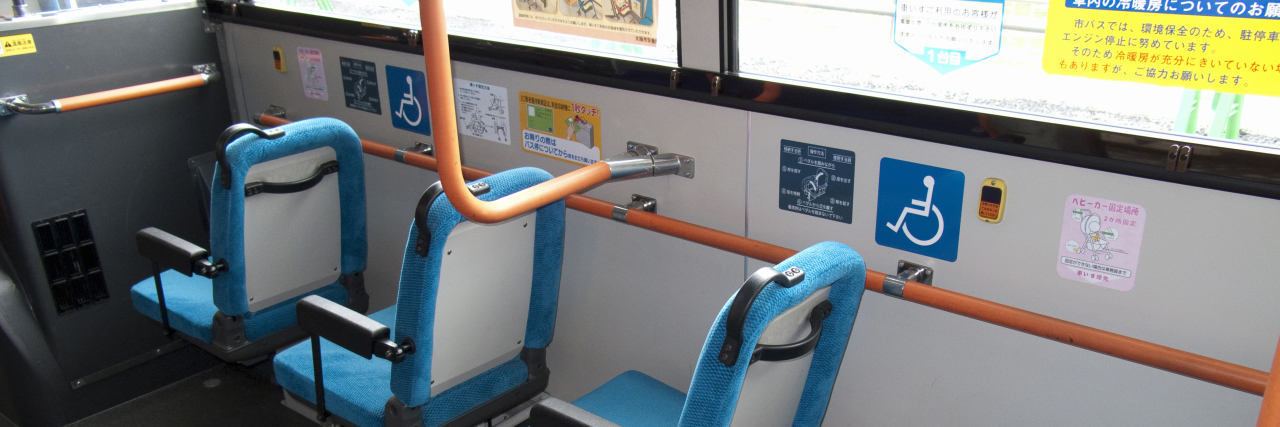 Priority seats on bus with disability symbol.