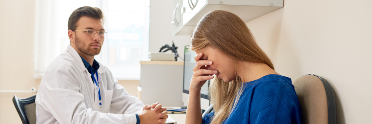 Being Forced to Taper Off Pain Medication Upset woman in doctor's office.