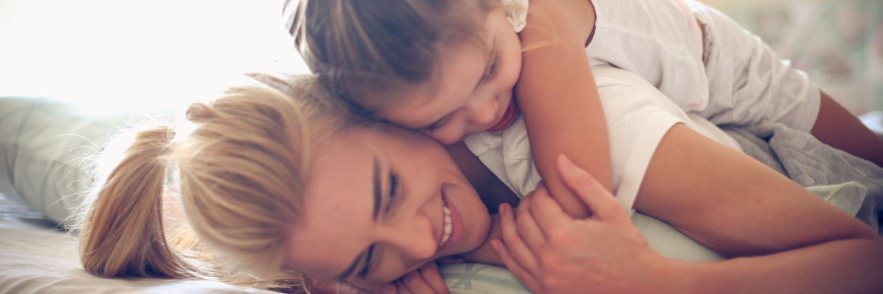 Parenting With Ehlers-Danlos Syndrome Mother and daughter cuddling.