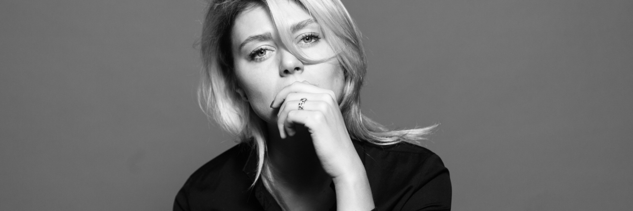 How Lupus Has Taken Away My Voice black and white photo of a woman with her hand over her mouth