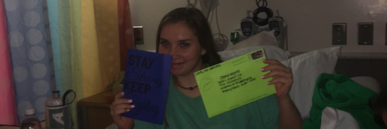 Grieving Your Hopes and Dreams Because of Chronic Illness the author in a hospital bed holding up cards and envelopes
