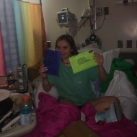 the author in a hospital bed holding up cards and envelopes