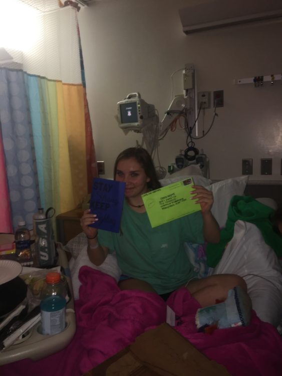 the author in a hospital bed holding up cards and envelopes