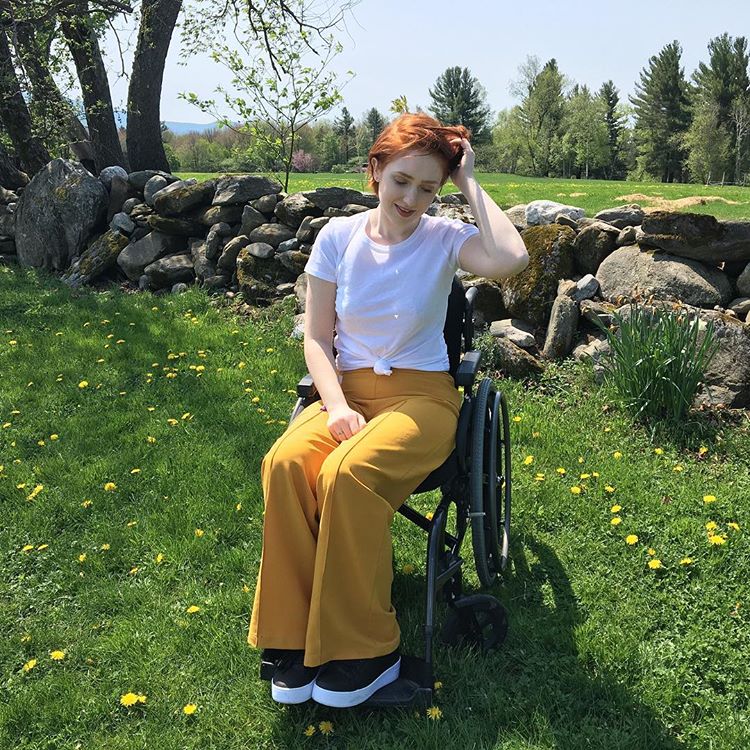 the author in her wheelchair, outside in the grass