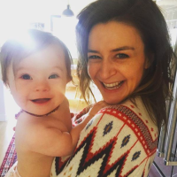 Instagram image of Caterina Scorsone holding her daughter, Pippa, both smiling at camera.