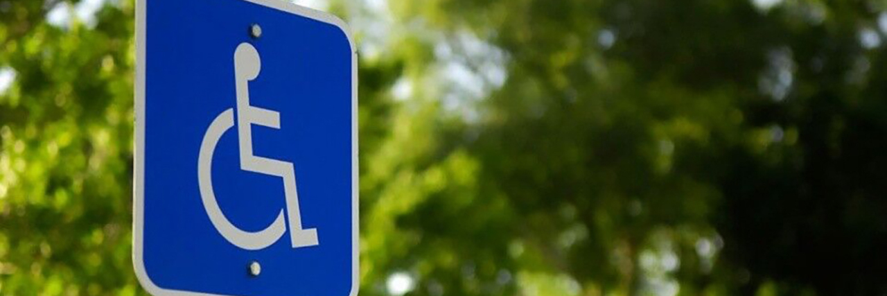 Improving Your Company's Disability Accessibility Wheelchair symbol on an outdoor sign.