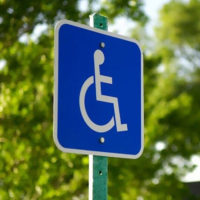 Wheelchair symbol on an outdoor sign.