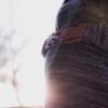 An image of a pregnant person's stomach with the sunlight in the background.