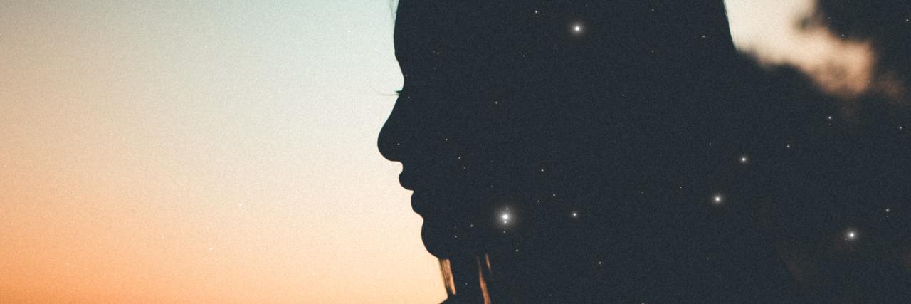 Being Diagnosed With PTSD After Remembering Sexual Assault photo of woman backlit by sunset with crescent moon visible and bokeh lights