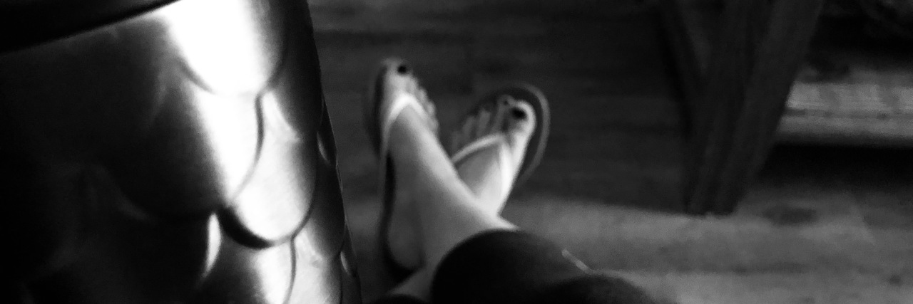 Finding the Right Massage Therapist for Your Needs black and white photo of a woman holding her coffee cup in the waiting room of a spa