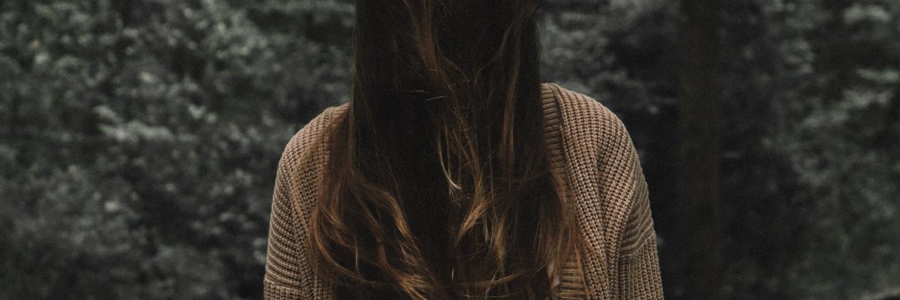 Being OK With Anger From Personality Disorders woman in woods with hair hiding face