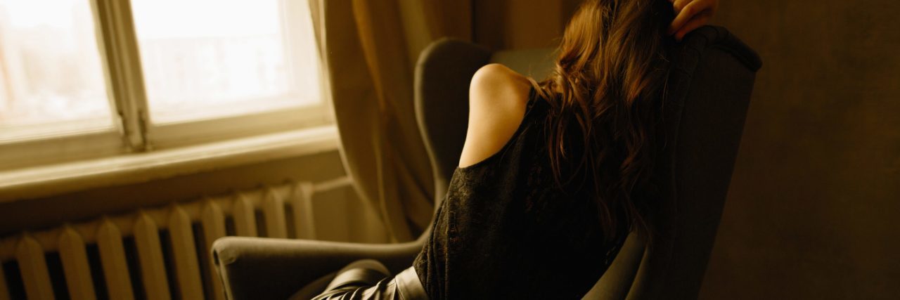 Depression, Family and Feeling Always Exhausted woman curled up on chair looking exhausted