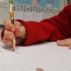 kid holding pencil with thumb hyperextended