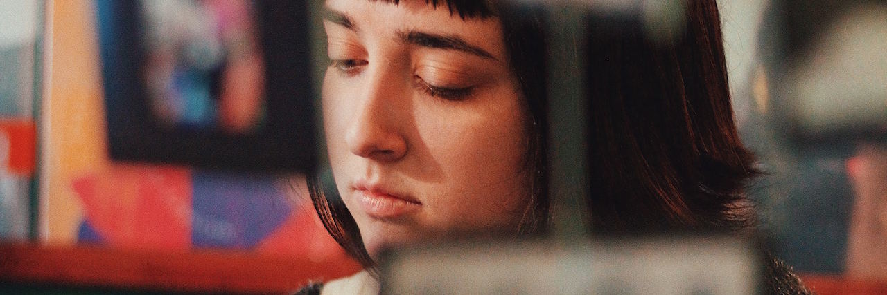 Mental Illness Makes It Hard to Reach Life Goals A woman looking down