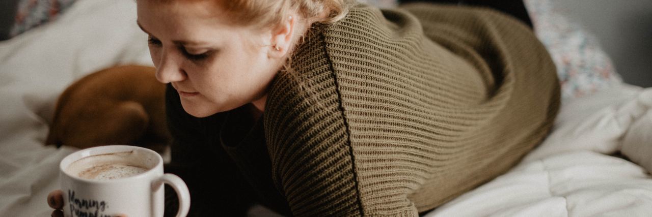Feeling Anxious Because of Other People's Actions woman lying on bed holding mug of coffee saying "morning pumpkin"