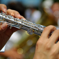 Woman's hands playing flute.