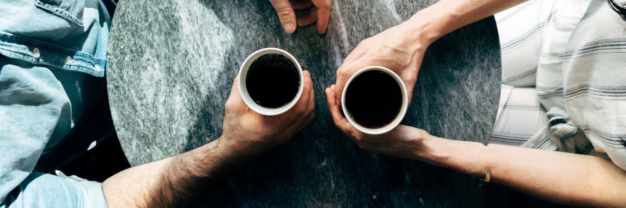 Uncomfortable Talking About Depression close up of two people having coffee overhead view
