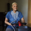 Keisha, African-American young woman sitting in a scooter.