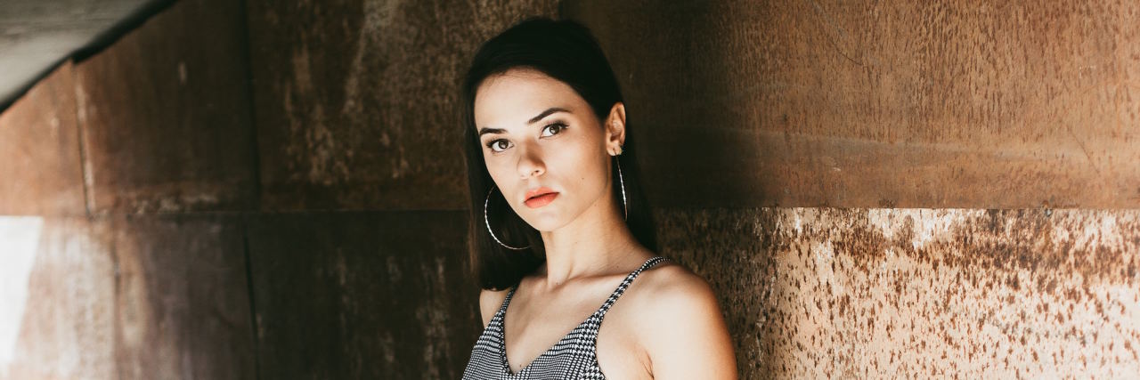 Hypervigilance and Anxiety woman in plaid tanktop leaning on wlal