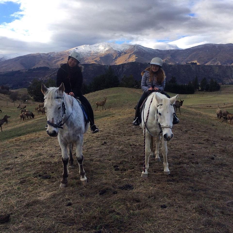 Shannon and a friend riding horses.