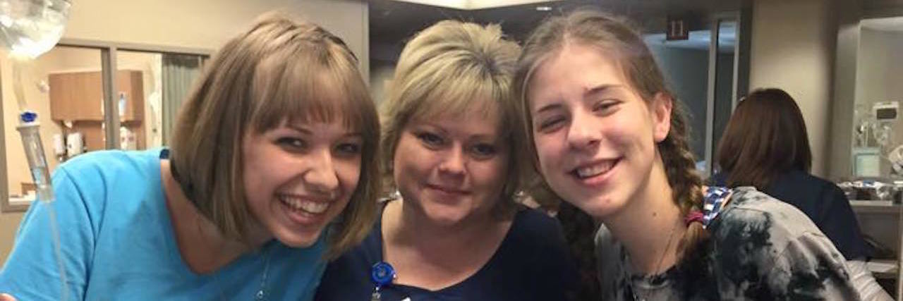 megan smiling with her nurse and friend during an infusion