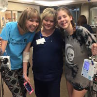 megan smiling with her nurse and friend during an infusion