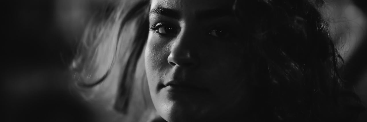 When People Expect You to 'Prove' Your Invisible Illness Is Real black and white photo of a woman's face, looking serious