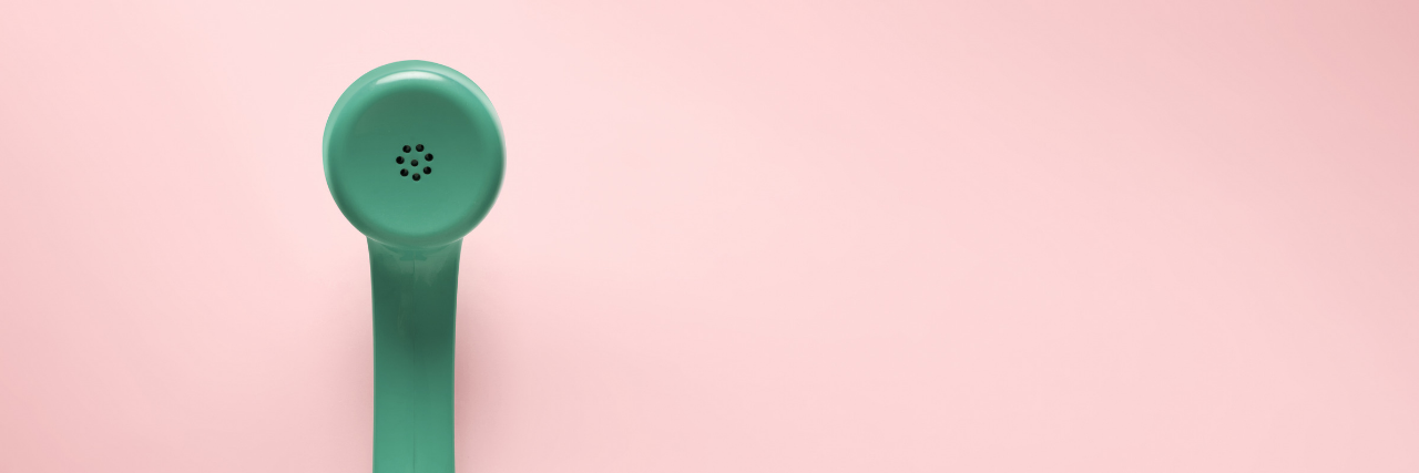 Green telephone with pink background