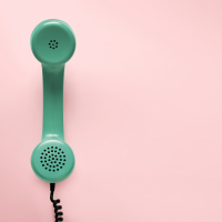 Green telephone with pink background