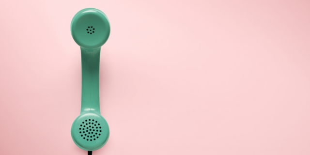 Green telephone with pink background