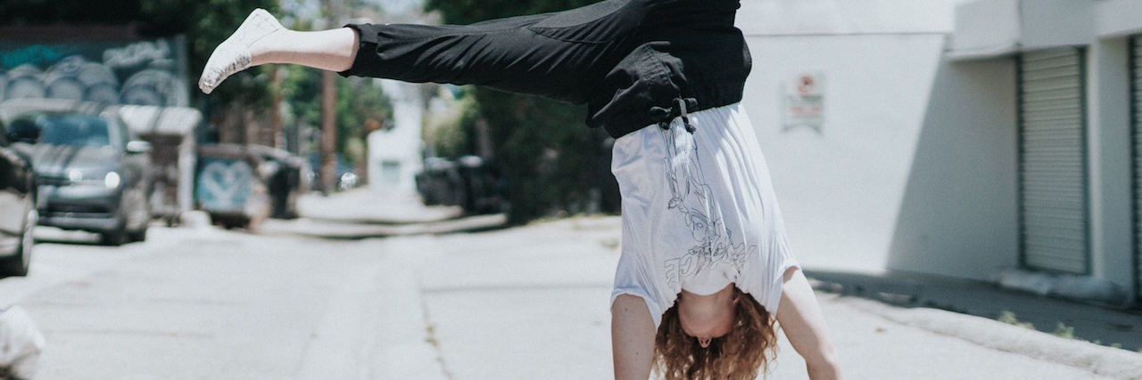 What Perfectionists Should Know About Eating Disorders A woman doing a cartwheel