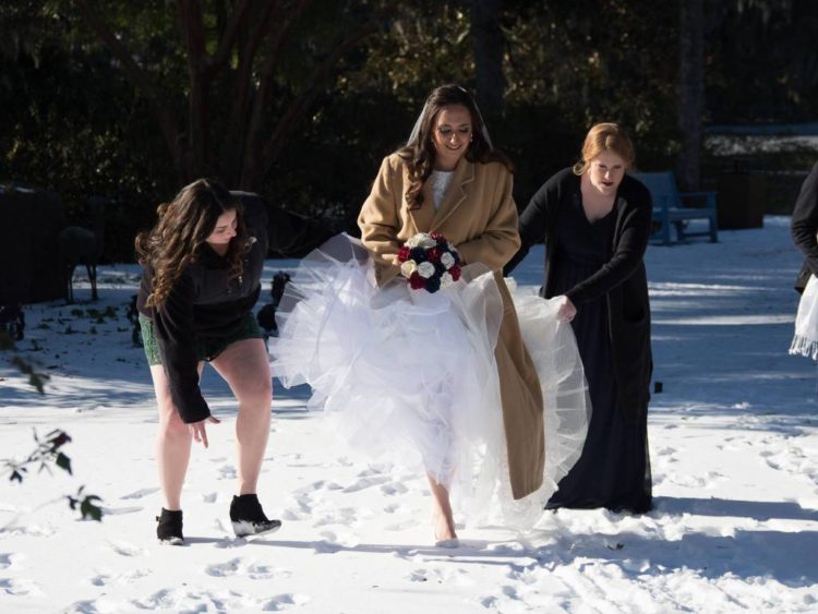 the author walking through the snow wearing her wedding dress
