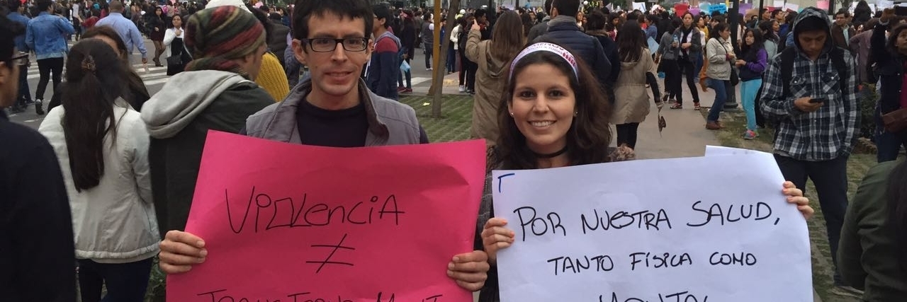 What It's Like When Your Brother Has Schizophrenia The author and her brother, holding signs written in Spanish