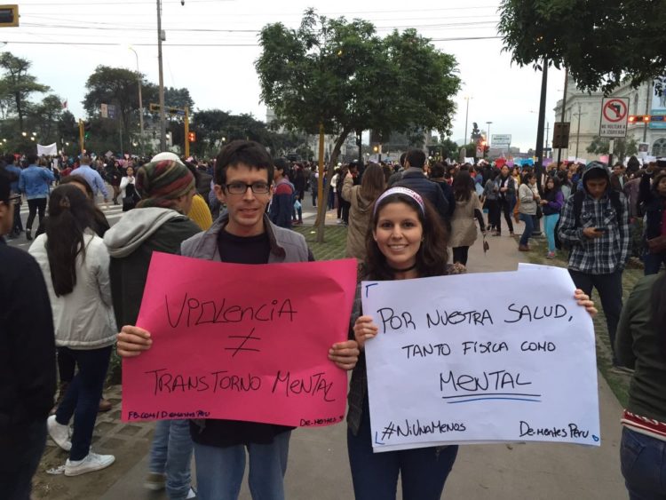 The author and her brother, holding signs written in Spanish