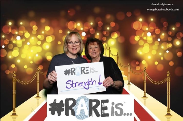 the author and her friend holding a sign about strength for LEMS