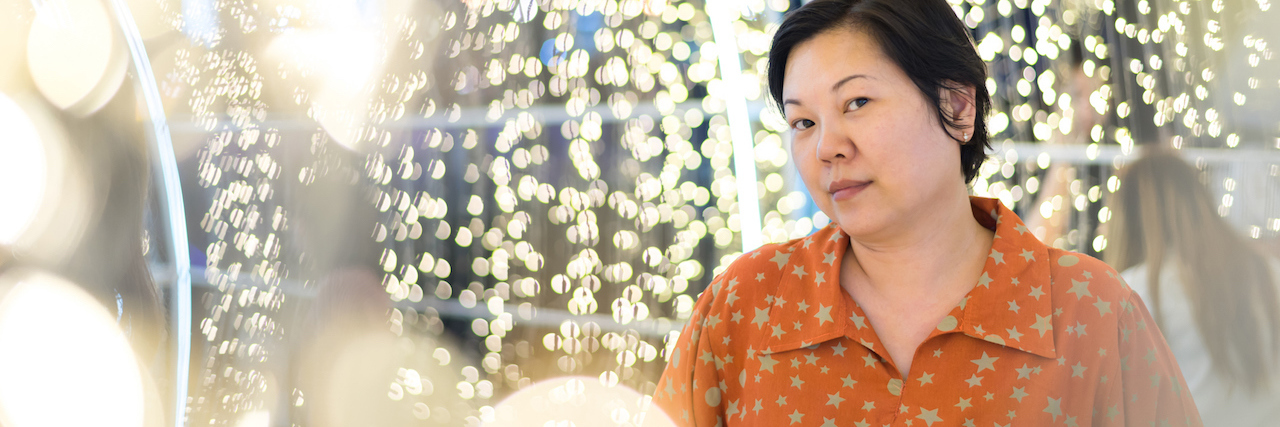 BPD: How to Stop Living Life From Crisis to Crisis A woman surrounded by twinkle lights