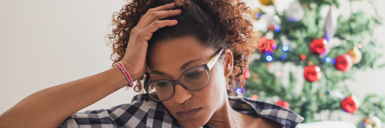 Holiday Season Survival Tips for Migraine Warriors Pensive and black woman during christmas celebration days