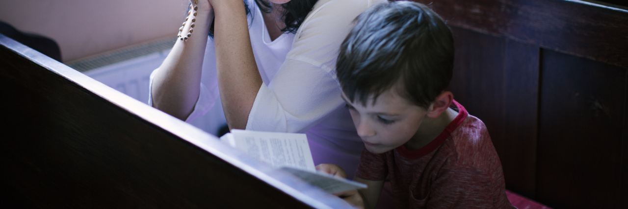 Kindness for My Child on the Autism Spectrum Begins With Parents Woman looking over at son sitting on church pews.