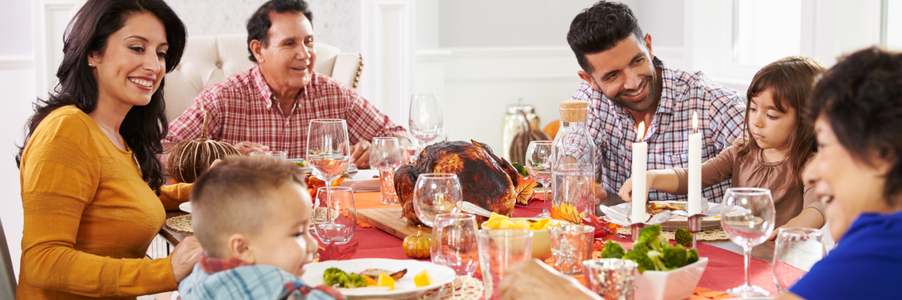 Being Thankful When Parenting a Child With a Rare Disease Family With Grandparents Enjoying Thanksgiving Meal At Table