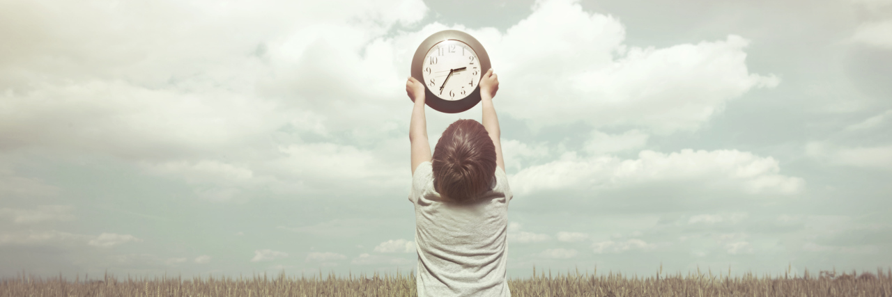 My Son With a Disability Reminds Me It's OK to Take Our Time Little boy lifting clock above his head.
