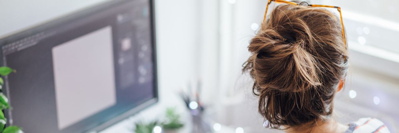 How I Got Accommodations for My Chronic Lyme Disease Woman in front of her computer, which appears to have some type of code on it.