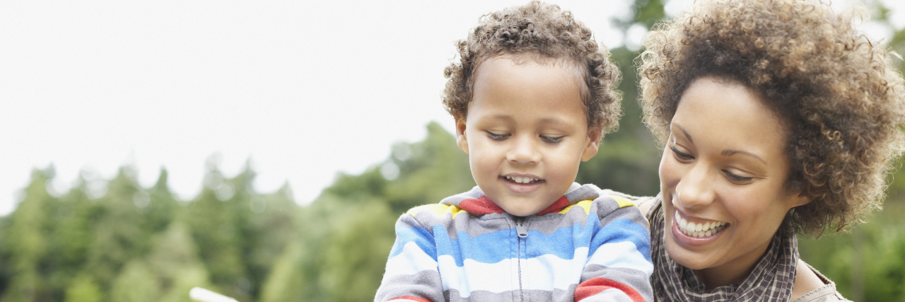 Things Parents of Kids With Invisible Disabilities Want You to Know Mother and son playing with butterfly net in park.