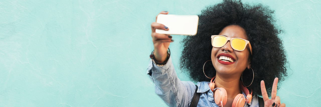 African-American woman posing for a selfie.