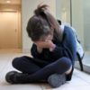 Girl crying at school because of bullying.