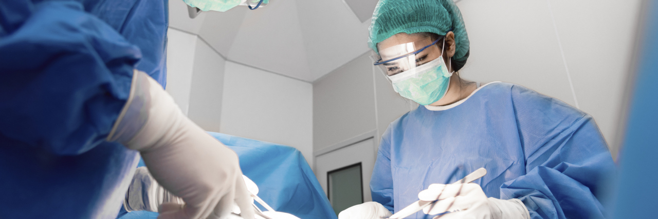 Report Finds Spinal Cord Stimulators Caused Thousands of Injuries Doctors and nurse with tools in hands making surgery in operation room. Health care and Hospital concept