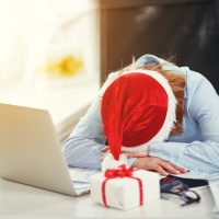 woman tired, asleep working at computer at Christmas