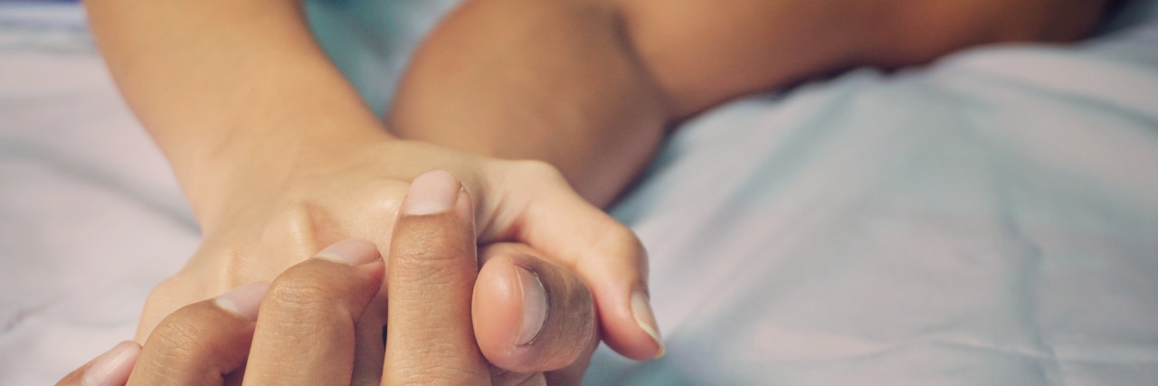 How I Learned to Navigate Sex and Intimacy With Multiple Sclerosis man and woman's hands in bed