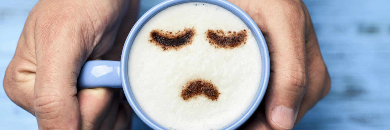 What to Do If You Have Low Self-Esteem man with a cup of cappuccino with a sad face