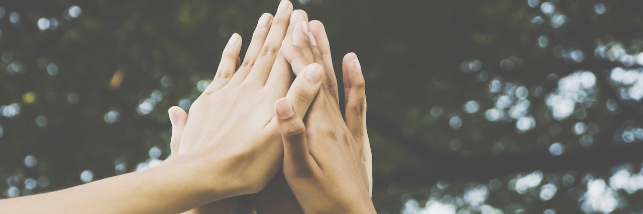 CDC Says Suicide Rates Went Up Again in 2017 Hands holding up in a high five.
