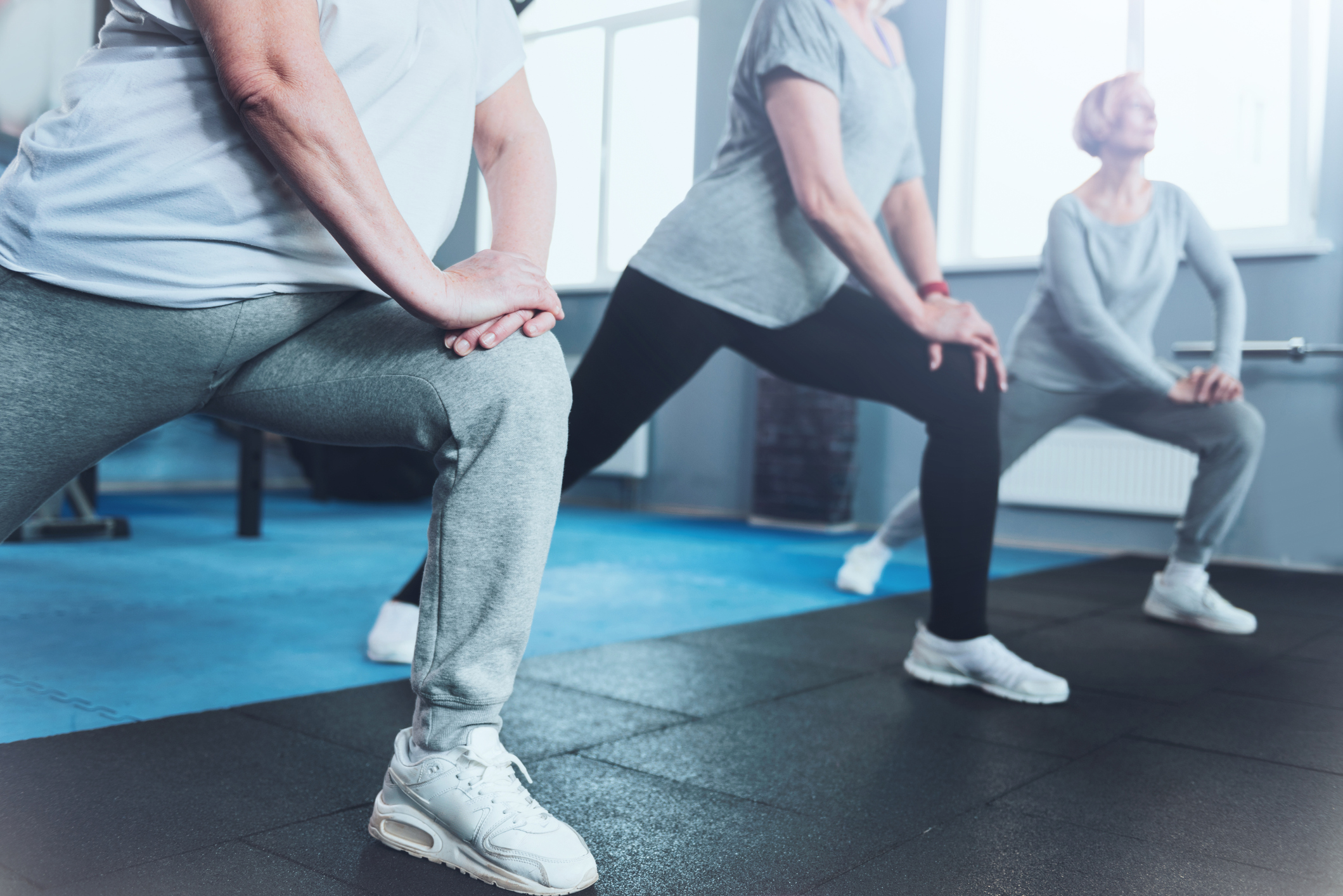 group of women doing lunges at the gym